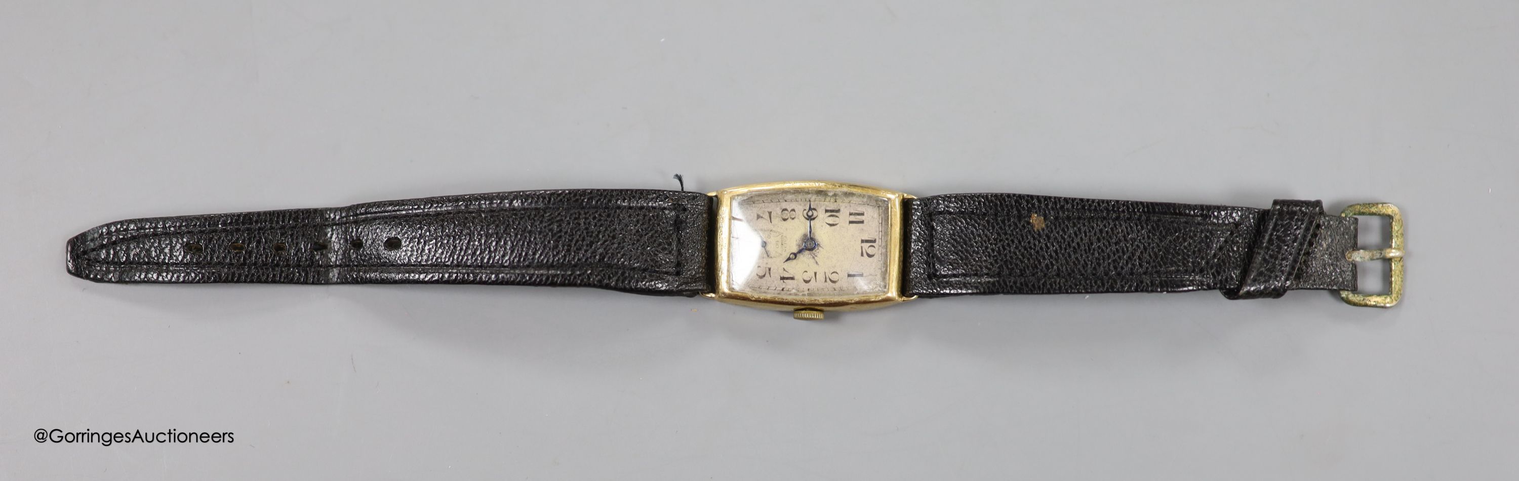 A gentleman's 1930's 9ct gold manual wind tonneau shaped wrist watch, with case back inscription, on leather strap